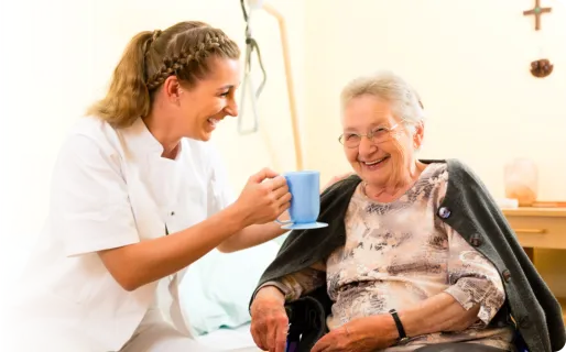 nurse and elderly woman laughing