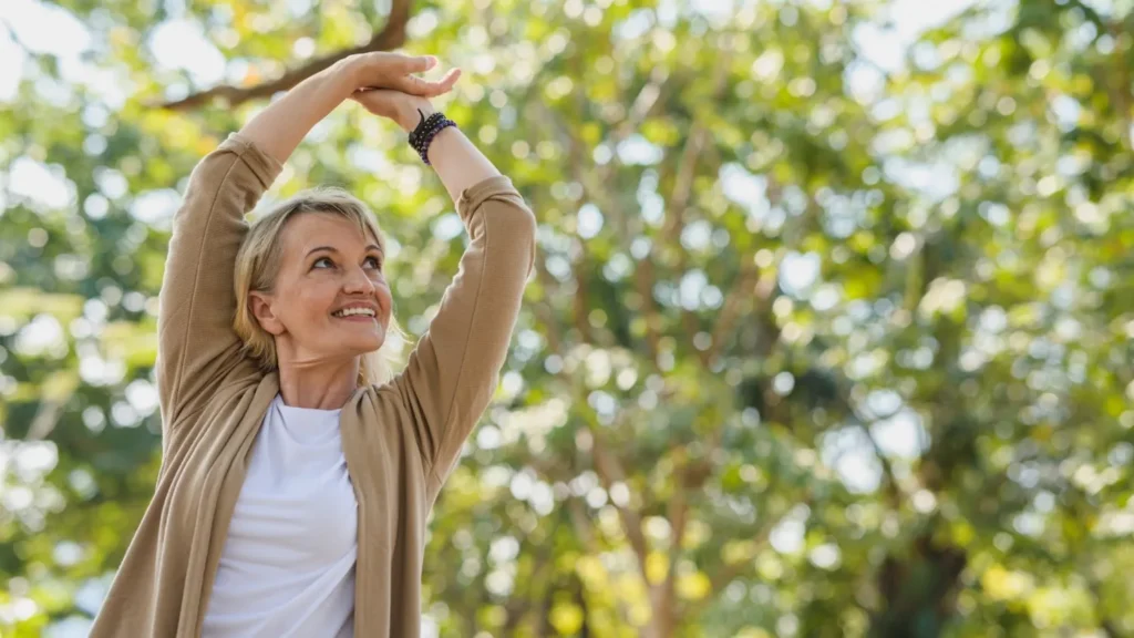 woman stretching under trees