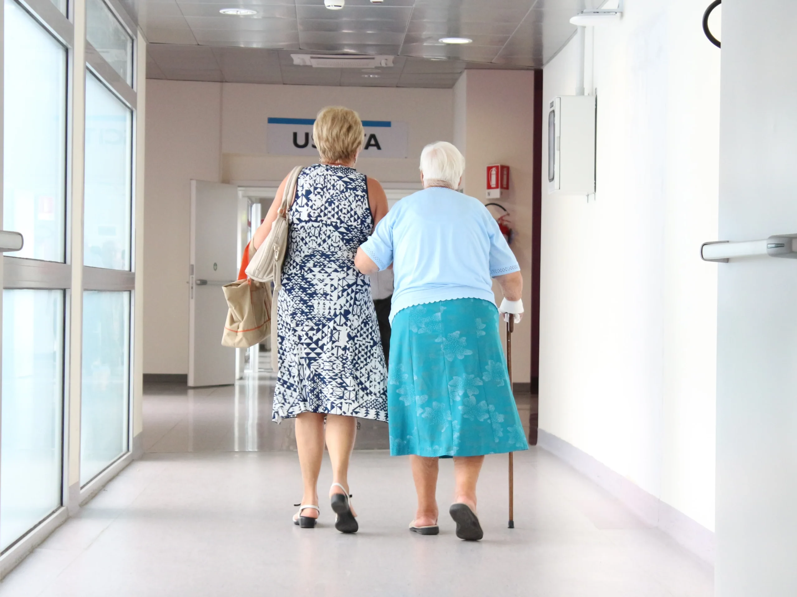 woman walking with elderly mother to seek external support for elderly care