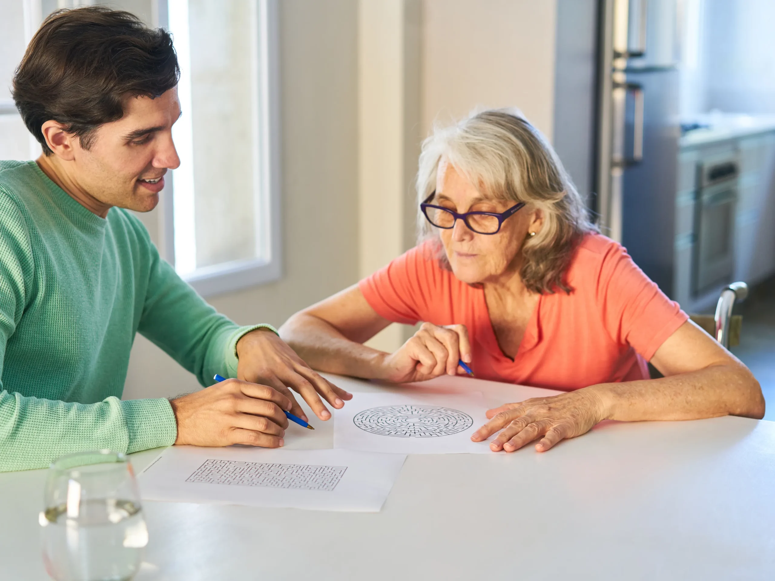 man playing memory game with an elderly woman